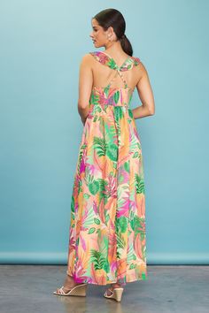 Featuring a long, flowing silhouette that moves gracefully with each step, this maxi dress boasts a sunset-hued tropical print and a surplice-style bodice with pleat detailing. Ruffled straps crisscross the back. A bit of smocking offers a flattering, comfortable fit. •Surplice-style bodice •Ruffled crisscross straps •Pleated waist •Smocked back •Lined Item Number: 99847 100% POLYESTER Tropical Maxi Dress For Spring, Tropical Style Spring Maxi Dress, Tropical Sleeveless Dress With Smocked Back, Sleeveless Tropical Dress With Smocked Back, Spring Maxi Dress With Crisscross Straps, Maxi Dress With Crisscross Straps For Vacation, Vacation Dresses With Crisscross Straps And Maxi Length, Pink Beach Dress With Crisscross Straps, Pink Maxi Dress With Smocked Back For Vacation