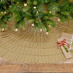 a present wrapped in brown paper sitting under a christmas tree