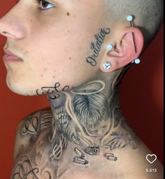 a man with tattoos and piercings on his neck