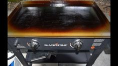 a black stone grill with two burners on the front and one is brown in color