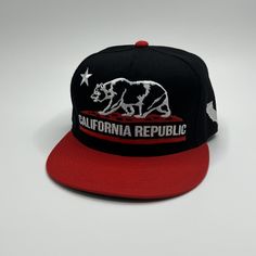 California Republic Snapback - Red/Black Bill Our California Republic flat bill snapback, exquisitely embroidered, brings a slice of sunny, laid-back vibes to your everyday style. Crafted with premium materials and adorned with a striking California bear, this hat is your go-to accessory for effortlessly showcasing your love for the Golden State. - 🌞 Standout Style: Boldly embroidered California Republic bear on a sleek flat bill snapback for an eye-catching touch. - 🧢 Superior Quality: Made w Novelty Snapback Hat With Flat Bill, California Bear, Flat Bill Hats, California Republic, Embroidered Hat, Quality Hats, Embroidered Hats, Cute Hats, Golden State