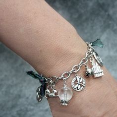 This Ban Druidh charm bracelet is the perfect accessory for a Scottish Witch.  The charm bracelet has a thimble, long associated with witches and love spells, a real quartz crystal ball for a little scrying, a blue flash labradorite bead for a touch of magic, and a white moonstone bead, sometimes called the stone of destiny. There's also a gorgeous stretching cat, a Celtic knot, a crescent moon, a dragonfly, a turreted Scottish castle, and a B for Ban Druidh. I've embelished the bracelet with a Gothic Charm Bracelet, Witch Bracelet, Dark Spells, Witch Gift, White Witch, Wardrobe Accessories, Witchy Jewelry, White Moonstone, Labradorite Beads