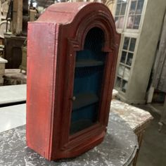 a red cabinet sitting on top of a table