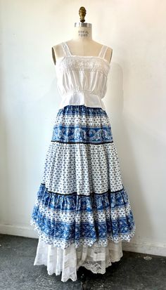 Vintage French Provençal maxi skirt with intricate blue and white pattern Easy to style breezy 100% cotton skirt with French design. Made in France by the brand Solymod. Pairs perfectly with a white blouse (shown with Victorian singlet blouse - also available in the shop) Best fits xs-medium Can fit up to size medium Waist: 24” - 30” In perfect condition with no wear White Bohemian Dress With Gathered Skirt, Bohemian White Maxi Skirt With Gathered Detail, Bohemian White Gathered Maxi Skirt, White Bohemian Flared Skirt Dress, White Bohemian Dress With Flared Skirt, White Bohemian Cotton Skirt, White Cotton Bohemian Skirt, White Peasant Tiered Skirt, Ryan Roche