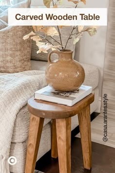 a table with a vase on top of it next to a couch