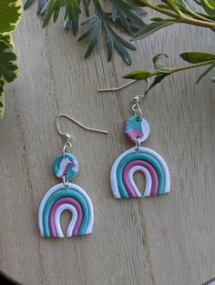 "At TerraceousDesign, our pieces are always inspired by nature in some way, shape, or form. These pastel earrings are a fun and funky way to show our appreciation for blending human creativity with nature's originality. The rainbow is a classic piece of nature's wonder. When sunlight hits a water droplet, some of the light is reflected. The electromagnetic spectrum is made of light with many different wavelengths, and each is reflected at a different angle, resulting in the colorful display we a Colorful Whimsical Earrings For Gifts, Whimsical Colorful Earrings For Gifts, Whimsical Earrings As A Gift, Green Playful Earrings, Playful Green Earrings With Ear Wire, Playful Rainbow Earrings With Ear Wire, Playful White Earrings With Ear Wire, Whimsical Adjustable White Earrings, Multicolor Whimsical Earrings