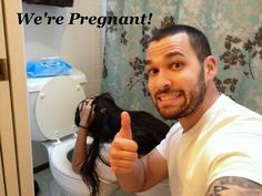 a man giving the thumbs up in front of a toilet with a woman on it