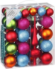 a clear box filled with assorted christmas ornament balls and candlesticks