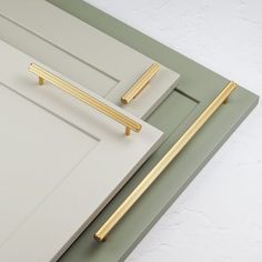 a close up of a tray with a gold handle on it and a white door