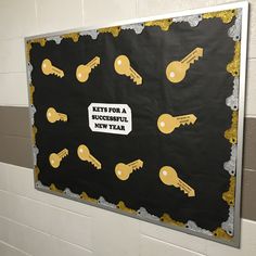 a bulletin board with keys for a successful year written on it in gold and black