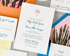 the wedding stationery is laid out on top of each other, including an envelope