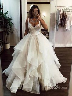 a woman is taking a selfie in her wedding dress while looking into the mirror