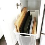 a white refrigerator freezer sitting inside of a kitchen next to a wooden cutting board