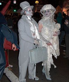 two people dressed up in costumes at an event