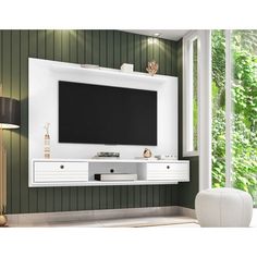 a white entertainment center with a flat screen tv mounted on it's side wall