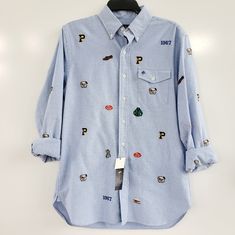 Ralph Lauren Men's Embroidered Varsity Oxford Button Down Shirt Size: Men's Small Color: Blue With Multiple Embroidery Can Dress Up Or Down Spare Buttons New With Tags Excellent Condition Fun, Preppy Look Casual Long Sleeve Shirt With Embroidered Logo, Light Blue Embroidered Cotton Shirt, Light Blue Cotton Embroidered Shirt, Blue Embroidered Collared Shirt, Casual Blue Embroidered Shirt, Light Blue Embroidered Casual Shirt, Casual Light Blue Embroidered Shirt, Ralph Lauren Blue Top With Buttons, Casual Long Sleeve Shirt With Embroidered Graphics