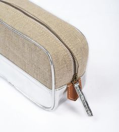 This multipurpose box bag or pouch can be used for cosmetics, toiletries, school supplies, jewellery..........and many more.It is very handy, light and protects the insides from getting wet as it is protected with faux leather on the outside and lined with quick dry polyester on the insideSilver faux leather with natural colour pure linen - makes it very stylish yet functionalThe inside has a zipped pocket too.The bag has zip closure.Size : height - 5 inches,          width at top - 7.5 inches; Large Capacity Rectangular Cosmetic Bag For Personal Use, Rectangular Zipper Pouch For Cosmetics And Toiletries, Large Capacity Pouch Cosmetic Bag For Gifts, Large Capacity Pouch As A Gift, Beige Rectangular Box Bag For Gifts, Large Capacity Rectangular Cosmetic Bag, Beige Rectangular Box Bag As A Gift, Beige Rectangular Box Bag As Gift, Beige Rectangular Box Bag Gift