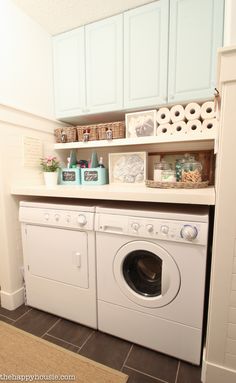 a white washer and dryer sitting in a laundry room next to each other