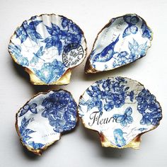 four blue and white plates with flowers on them sitting next to each other in front of a white background