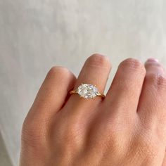 a woman's hand with a diamond ring on it