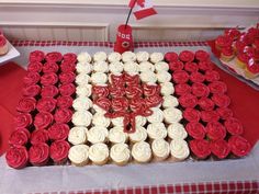 a flag made out of cupcakes on top of a red and white table cloth