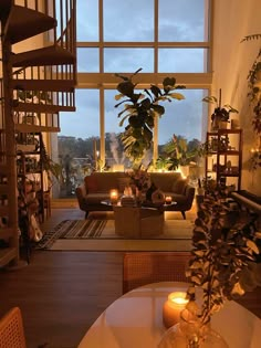 a living room filled with furniture and a fire place in front of a large window