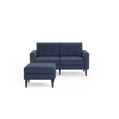 a blue couch and ottoman sitting next to each other