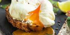 an open face sandwich topped with poached egg and cheese on toasted bread