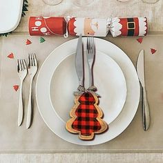 a christmas place setting with silverware and napkins