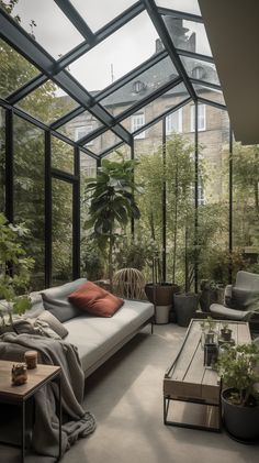 a living room filled with furniture and lots of plants inside of it's walls