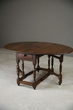 an old wooden table with two drawers on the top and one drawer at the bottom