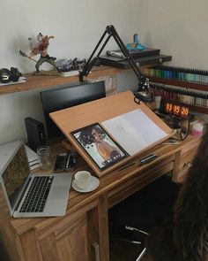 an open laptop computer sitting on top of a wooden desk