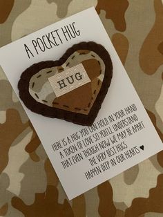 a piece of paper with a heart on it sitting on top of a camouflage background