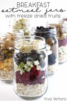 four mason jars filled with different types of fruit and veggies to make breakfast at home