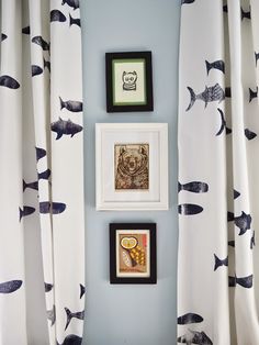 there are three pictures hanging on the wall next to each other with fish drawn on them