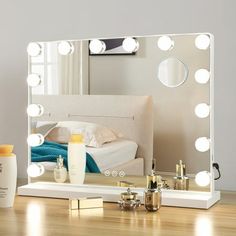 a vanity mirror sitting on top of a wooden table