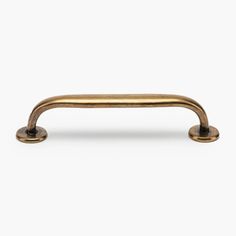 an antique brass pull handle on a white background