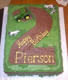 a birthday cake for a two year old with a tractor and farm animals on it