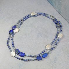 "Necklace Length: 36\" L Material:  4mm round-shaped sodalite, approx. 10x05mm lapis lazuli, freshwater cultured coin pearl, silver-tone spacer beads, 4mm faceted crystals in blue color, and blue thread. Clasp:  stainless steel gold-tone lobster claw clasp and jump ring Workmanship:  each bead is hand-beaded and knotted. https://www.etsy.com/shop/MYGEMSROCK" Blue Labradorite Necklaces For Healing, Blue Labradorite Gemstone Bead Necklaces, Blue Labradorite Gemstone Beads Necklace, Sapphire Beaded Necklaces With Natural Lapis Lazuli Stones, Lapis Lazuli Necklaces With Natural Stones, Lapis Lazuli Natural Stones Round Necklace, Round Lapis Lazuli Necklace With Natural Stones, Adjustable Blue Labradorite Necklace, Silver Beaded Necklaces With Lapis Lazuli Natural Stones