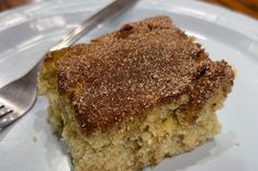 a piece of cake sitting on top of a white plate next to a knife and fork