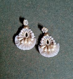 two pairs of white earrings with pearls on them