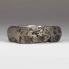 The rustic and irregular nature of our sandcast range comes from Justin's own technique; as the name suggests each ring is cast in sand. With a different mould used each time, every ring is totally unique - make it that little bit more special by sending us your own sand.  Textured sand cast ring in 14ct white gold – this ring is made by casting recycled white gold in beach sand. It is heavily textured but the casting gives the metal lovely contrasting stormy silver colours and makes it smooth t Untreated Sterling Silver Rings With Rustic Style, Rustic Silver Rings With Patina, Rustic Untreated Ring As A Gift, Rustic Untreated Ring For Gift, Rustic Untreated Rings For Gift, Rustic Silver Untreated Rings, Rustic Untreated Silver Ring, Sandcast Ring, Granite Texture