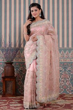 Beautiful light pink embroidered organza sari with scalloped border is a perfect drape for weddings and festive occasions! It comes with a matching blouse piece. Disclaimer: The actual product may vary slightly from the image. These are custom orders, hence expect slight variation in color, placement of the motif or buta. ESTIMATED DELIVERYBecause this is a custom order, it would take about 4 weeks from the date of purchase. RETURN POLICYThis product is a custom order and cannot be returned or e Pink Chanderi Pre-draped Saree With Sheer Dupatta, Pink Chanderi Pre-draped Saree For Reception, Designer Wear Pink Organza Pre-draped Saree, Designer Pink Organza Pre-draped Saree, Pink Tissue Silk Pre-draped Saree For Reception, Pink Organza Pre-draped Saree For Designer Wear, Pink Organza Pre-draped Saree For Wedding, Pink Organza Pre-draped Saree For Reception, Pink Organza Saree For Reception