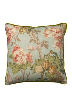 a floral pillow with green trim on the front and bottom, featuring pink flowers in various colors