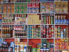 a store filled with lots of different types of food and drinks on shelves next to each other