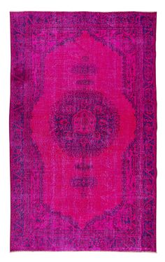 an old rug with pink and purple colors