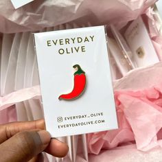 someone is holding up a red chili pepper broochie that says everyday olive on it