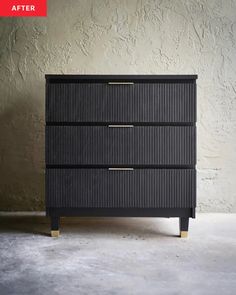 an image of a black dresser with gold trimmings on the top and bottom