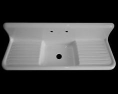 a white sink sitting on top of a black counter