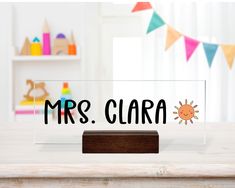 a clear acrylic sign that says mrs clara